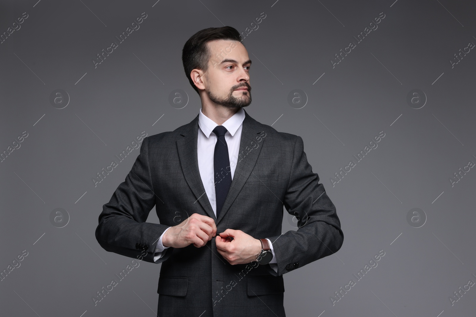 Photo of Confident man in classic suit on grey background