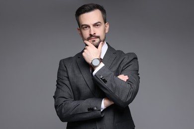 Photo of Confident man in classic suit on grey background