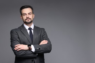 Confident man in classic suit on grey background. Space for text