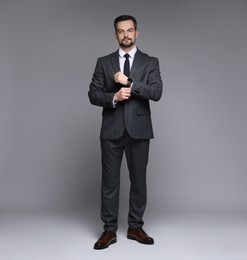 Photo of Handsome man in classic suit on grey background