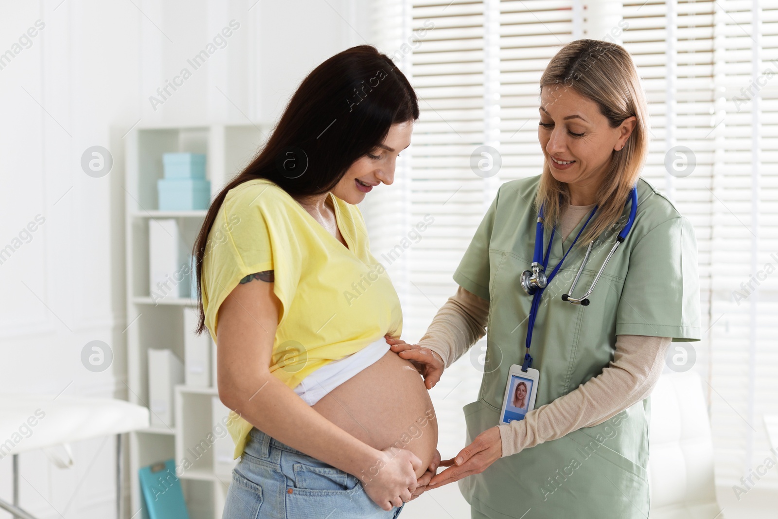 Photo of Pregnant woman having appointment with doctor in clinic