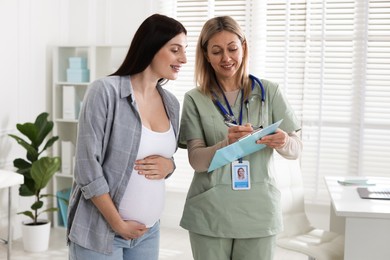 Pregnant woman having appointment with doctor in clinic