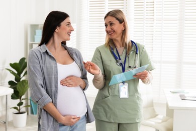 Pregnant woman having appointment with doctor in clinic