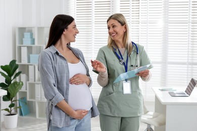 Pregnant woman having appointment with doctor in clinic