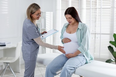 Pregnant woman having appointment with doctor in clinic