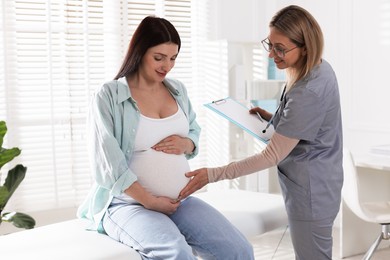 Pregnant woman having appointment with doctor in clinic