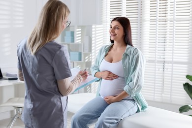 Pregnant woman having appointment with doctor in clinic