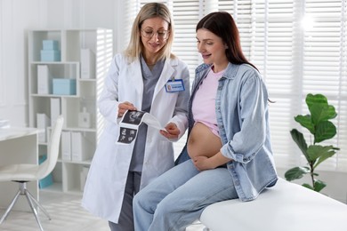 Photo of Pregnant woman having appointment with doctor in clinic