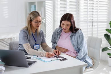 Pregnant woman having appointment with doctor in clinic