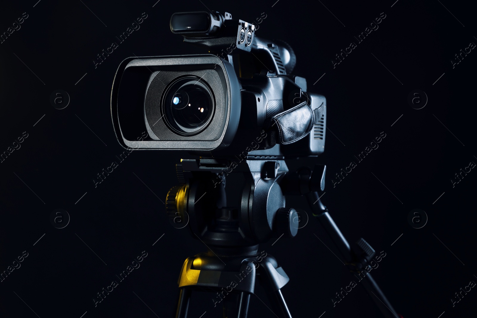 Photo of Modern video camera on black background, closeup