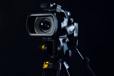 Modern video camera on black background, closeup