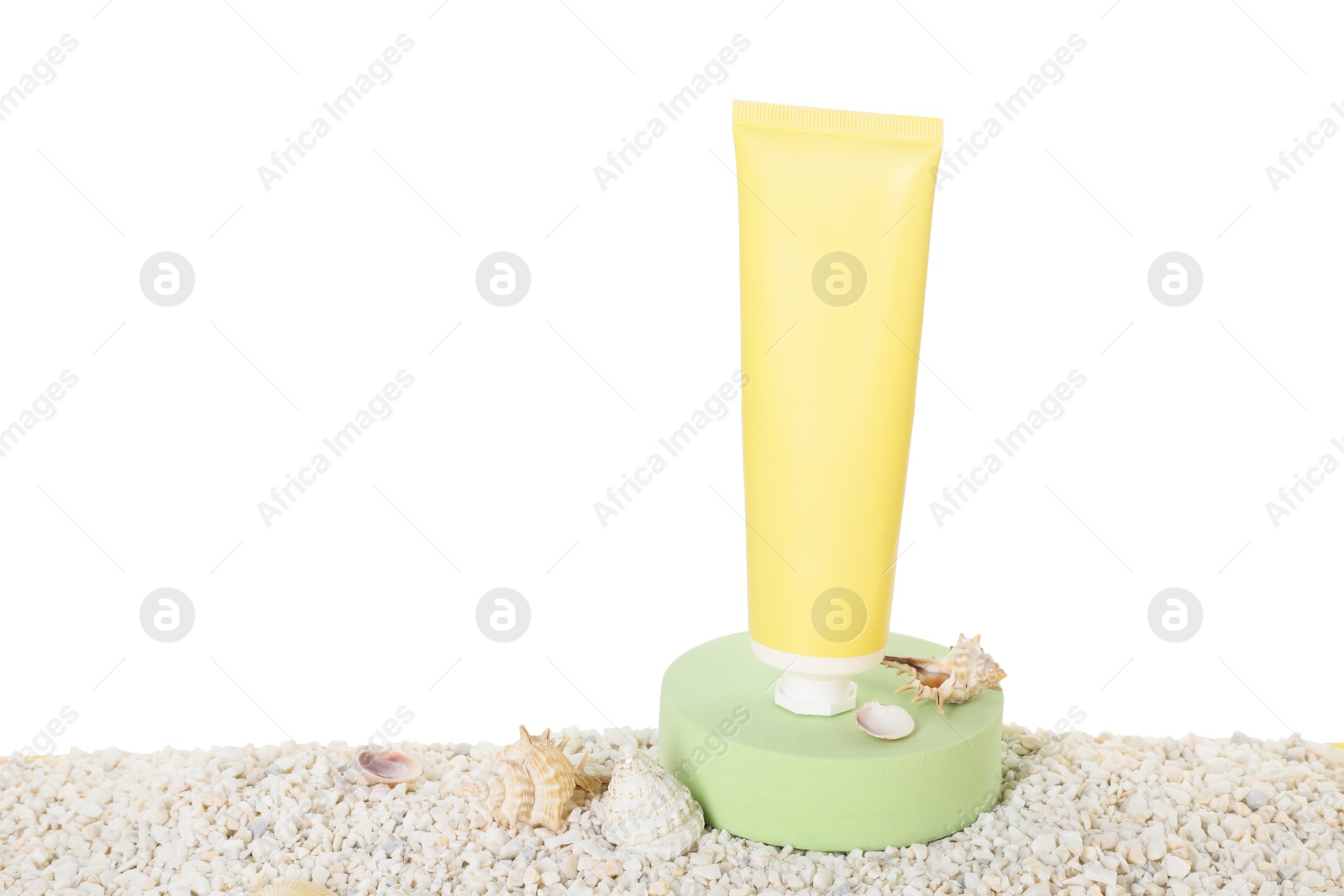 Photo of Tube of sun protection product and seashells on pebbles against white background