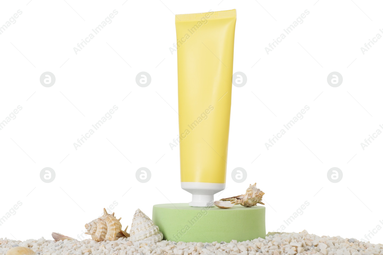 Photo of Tube of sun protection product and seashells on pebbles against white background