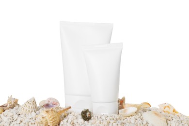 Photo of Tubes of sun protection product and seashells on pebbles against white background