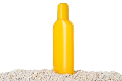 Photo of Bottle of sun protection product and seashells on pebbles against white background