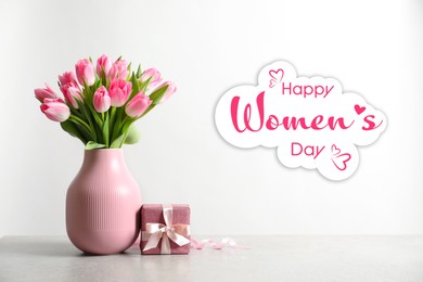 Happy Women's day card. Vase with beautiful pink tulips and gift box on table