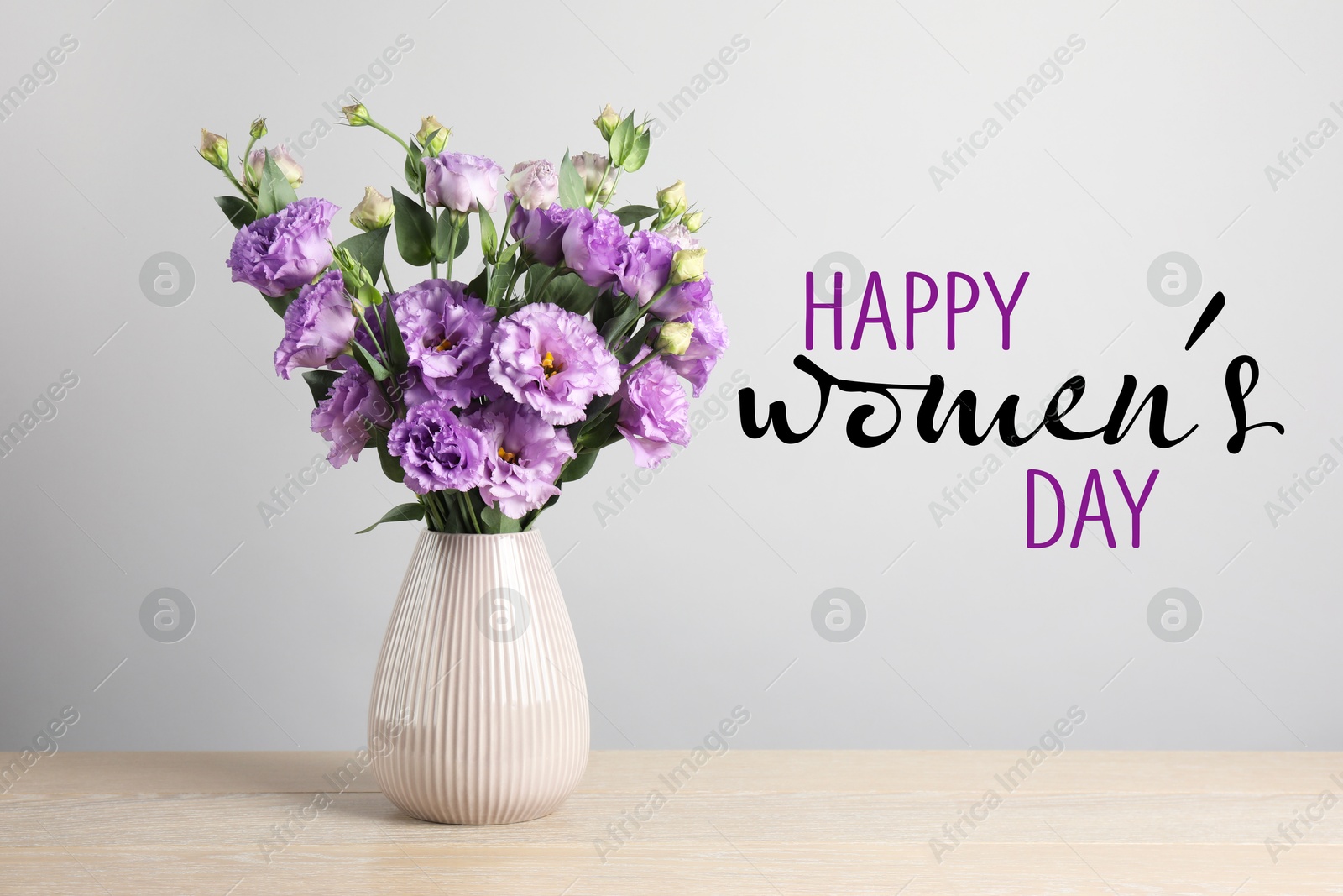 Image of Happy Women's day card. Vase with beautiful violet eustoma flowers on table