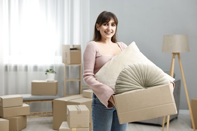 Moving day. Happy woman with her belongings in new home