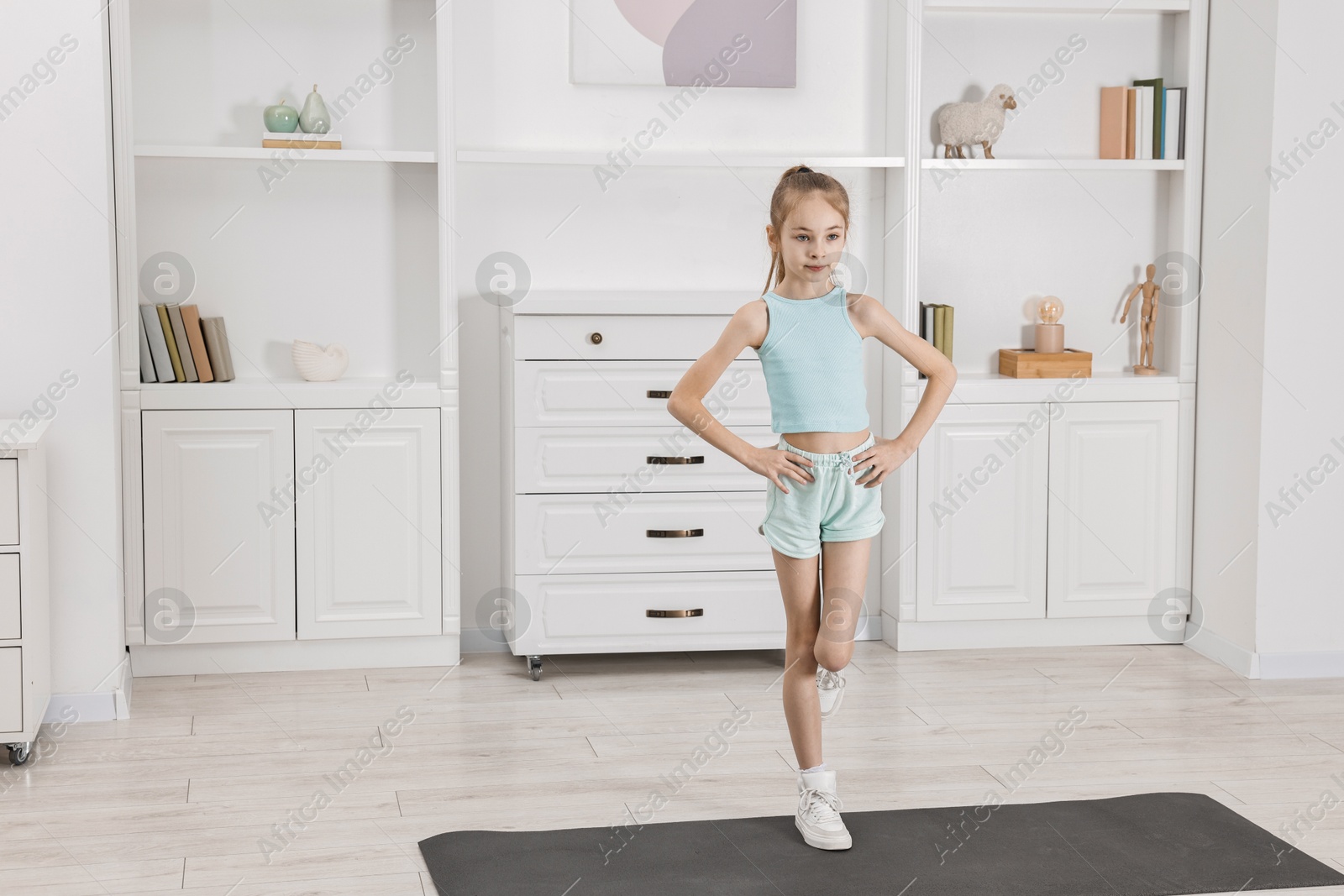 Photo of Little girl exercising at home, space for text. Morning routine