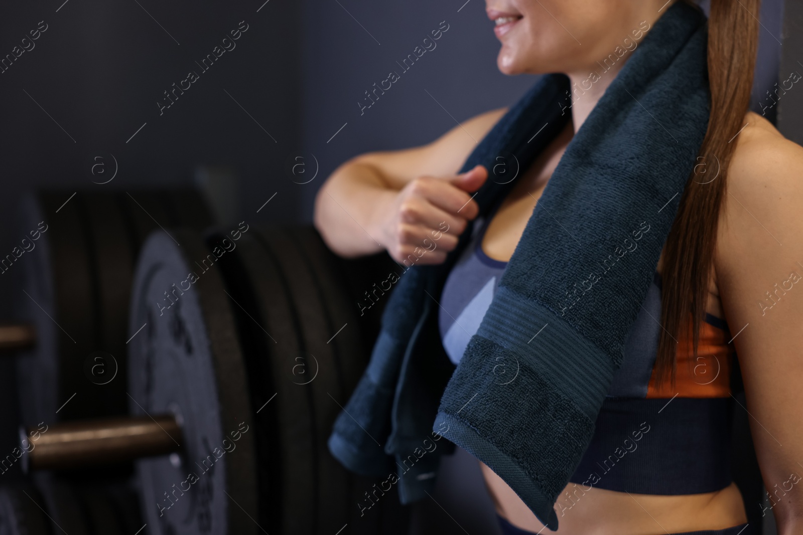 Photo of Happy woman with terry towel in gym