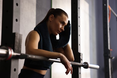 Photo of Happy woman with terry towel in gym