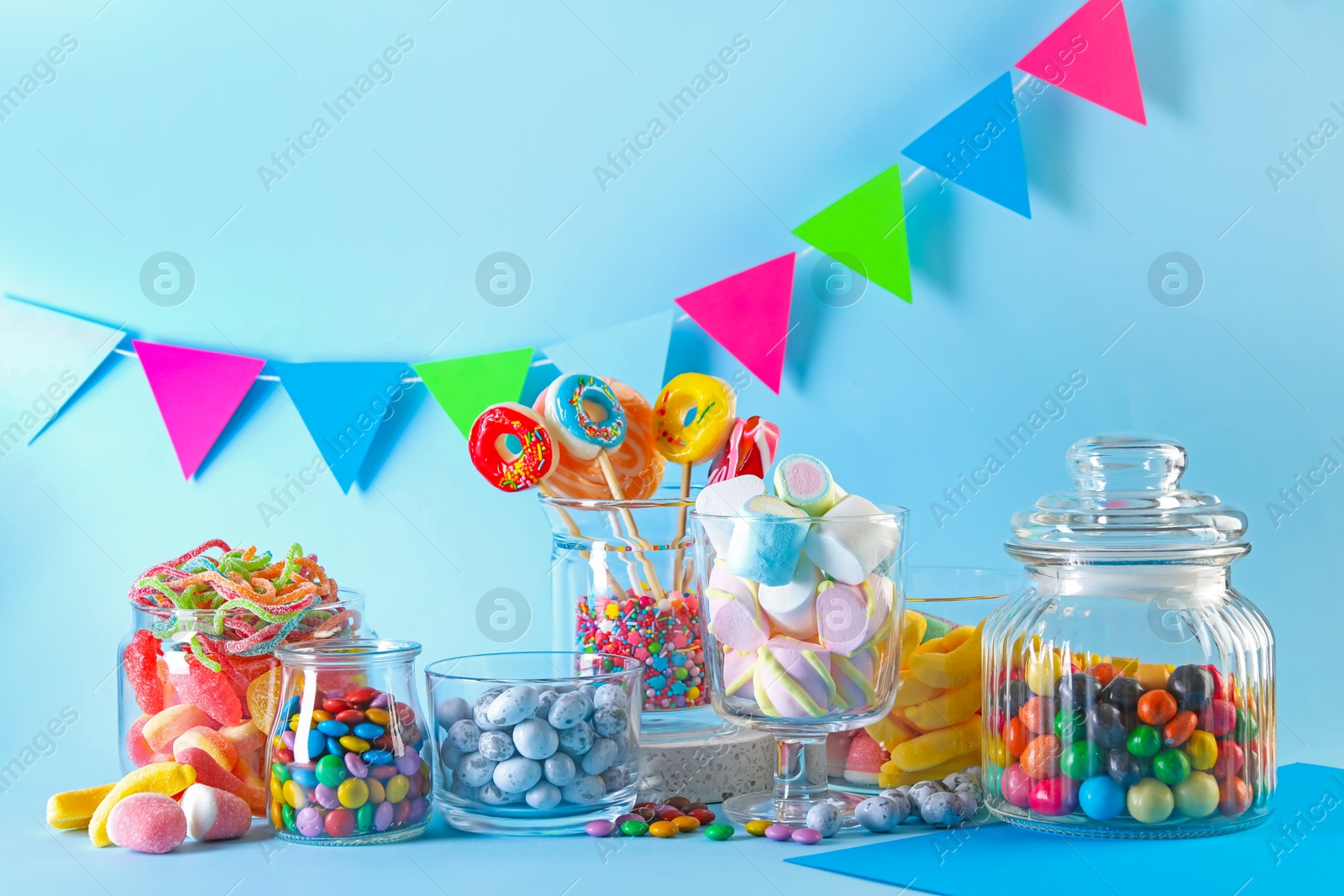 Photo of Candy bar. Many different sweets on light blue background