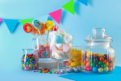 Photo of Candy bar. Many different sweets on light blue background