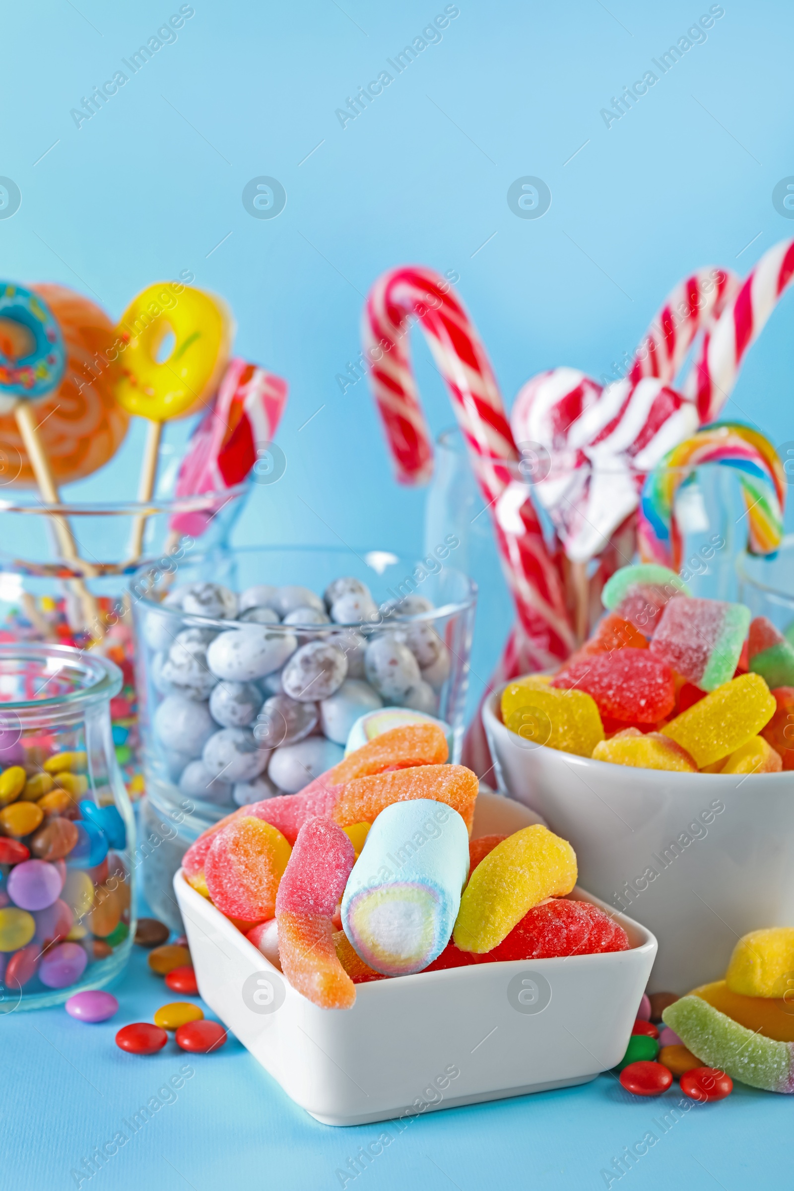 Photo of Candy bar. Many different sweets on light blue background, closeup