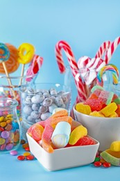 Photo of Candy bar. Many different sweets on light blue background, closeup