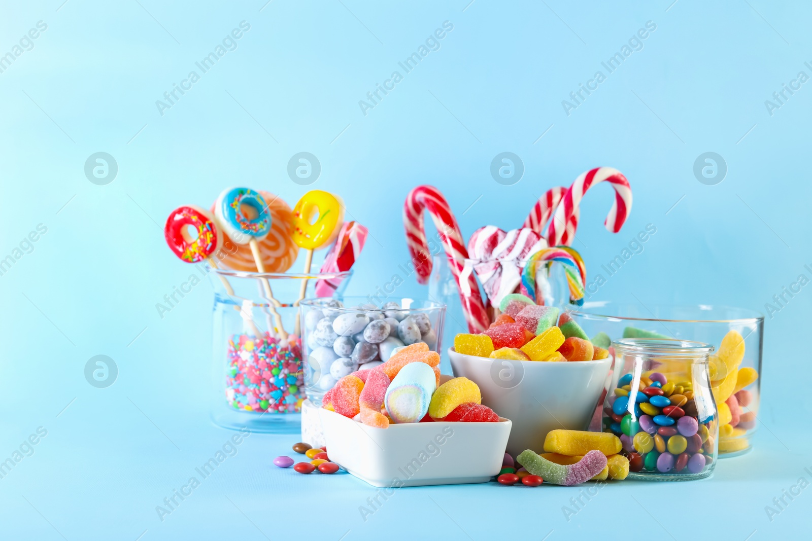 Photo of Candy bar. Many different sweets on light blue background. Space for text