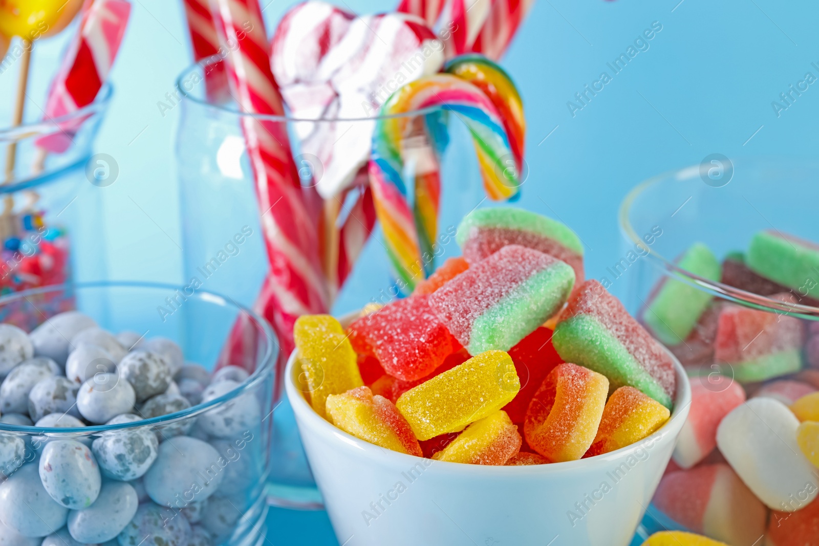 Photo of Candy bar. Many different sweets on light blue background, closeup