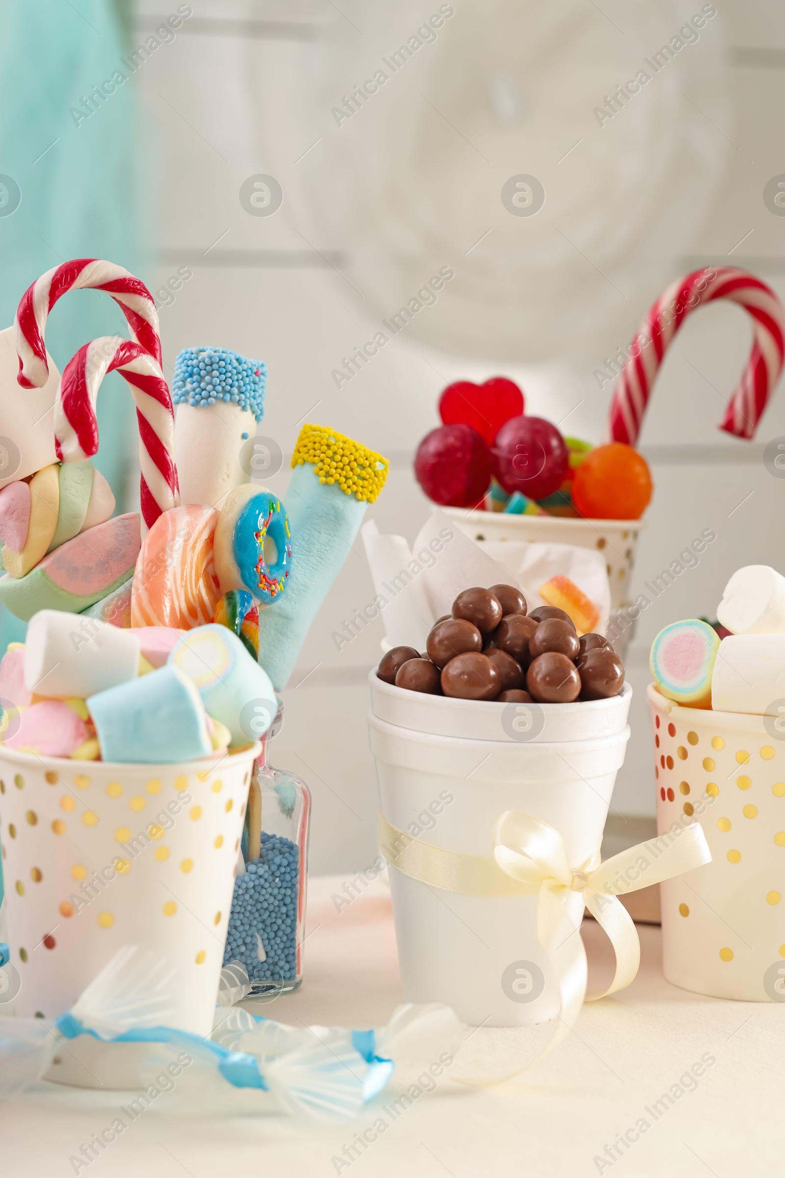 Photo of Candy bar. Different yummy sweets on white table indoors