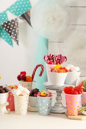 Photo of Candy bar. Different yummy sweets on white table indoors