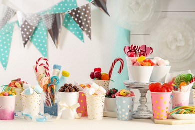 Photo of Candy bar. Different yummy sweets on white table indoors