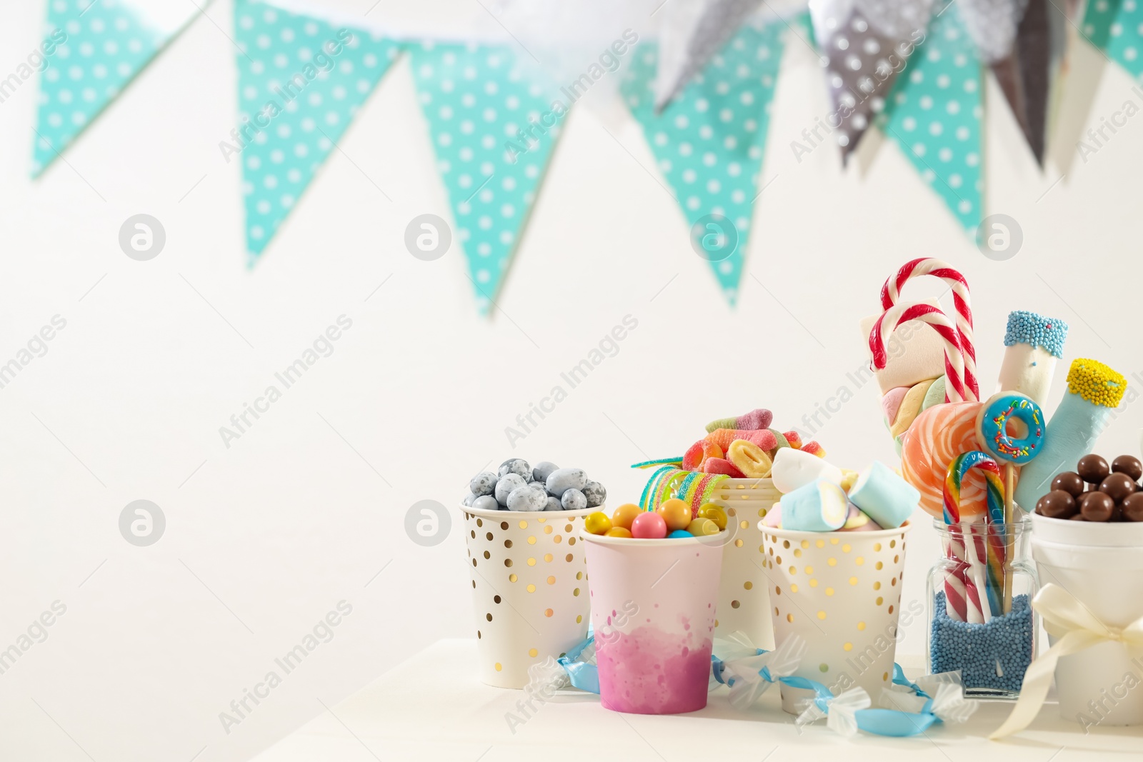 Photo of Candy bar. Different yummy sweets on white table indoors. Space for text