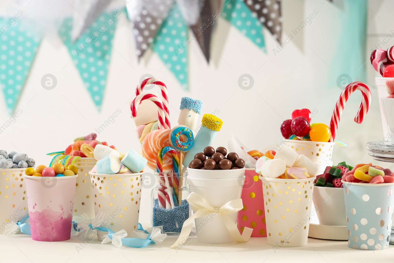 Photo of Candy bar. Different yummy sweets on white table indoors