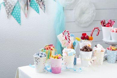 Candy bar. Different yummy sweets on white table indoors. Space for text