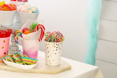 Candy bar. Different yummy sweets on white table indoors. Space for text