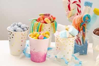 Photo of Candy bar. Different yummy sweets on white table against grey background