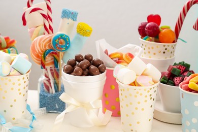 Photo of Candy bar. Different yummy sweets on white table against grey background