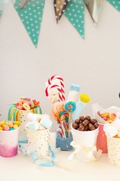 Photo of Candy bar. Different yummy sweets on white table indoors