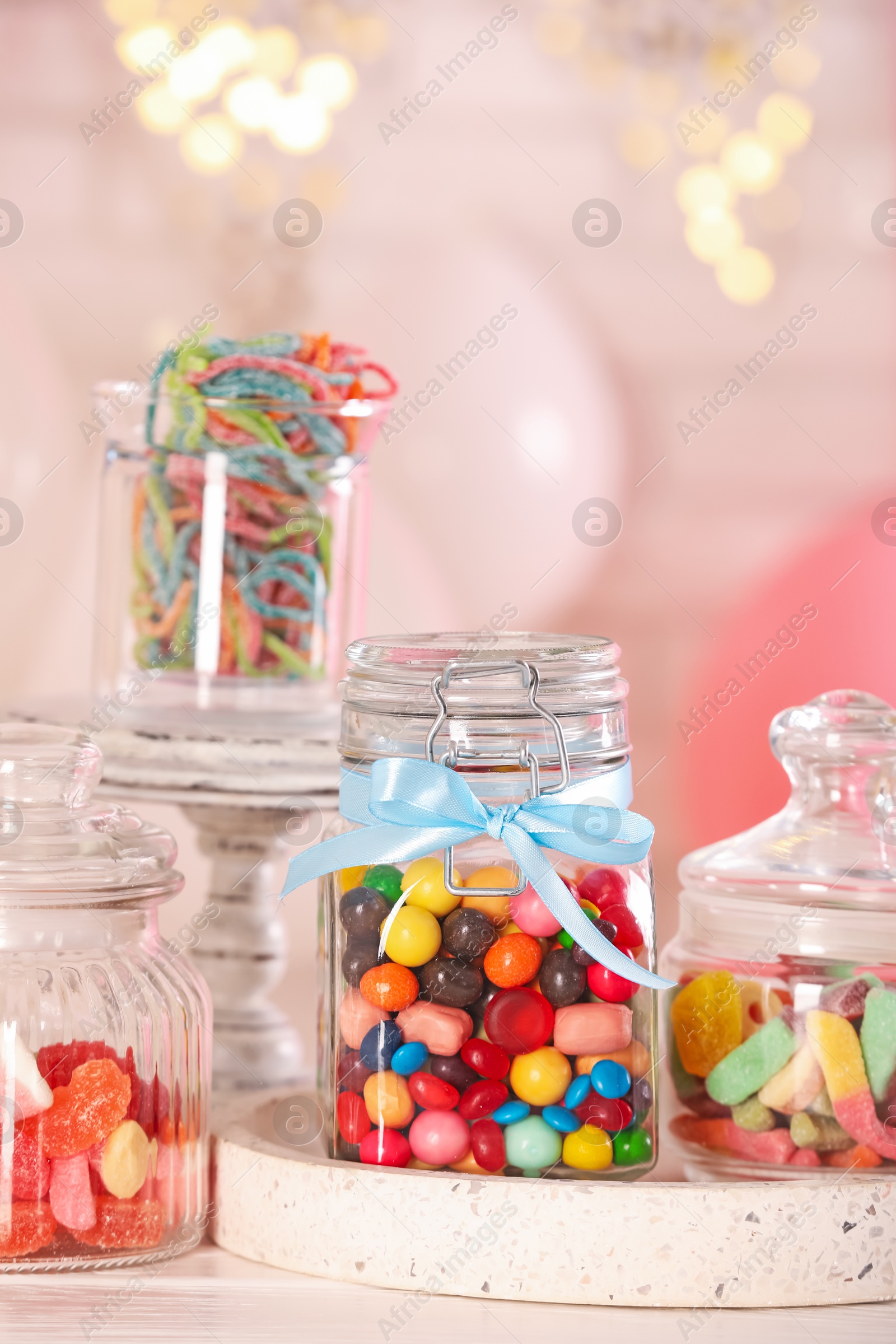 Photo of Candy bar. Many different sweets on white wooden table in festive decorated room