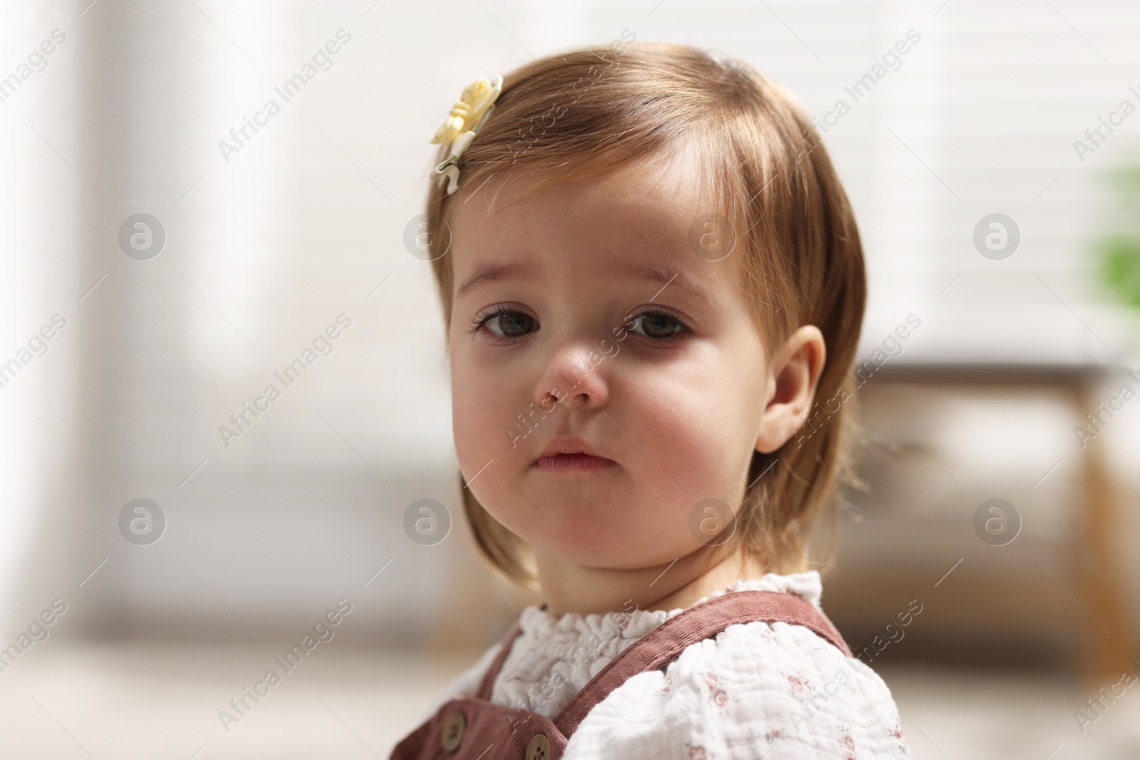 Photo of Portrait of sad baby girl at home