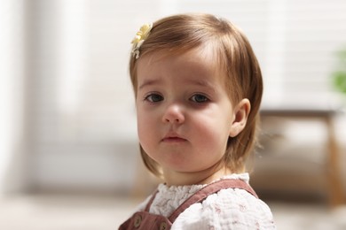 Photo of Portrait of sad baby girl at home