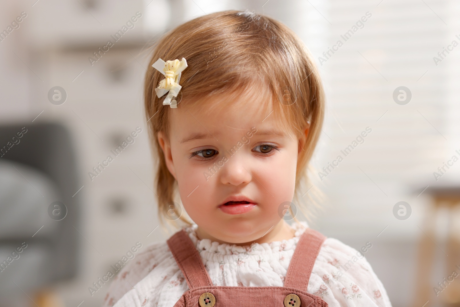 Photo of Portrait of sad baby girl at home