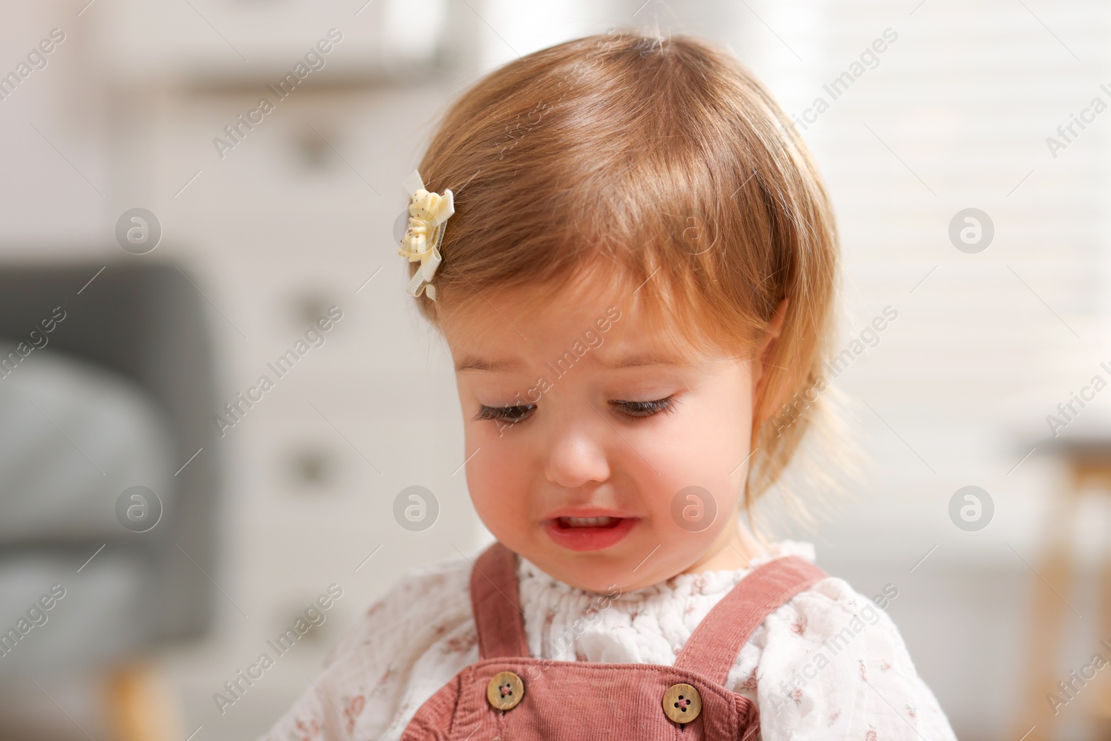 Photo of Cute little baby girl crying at home