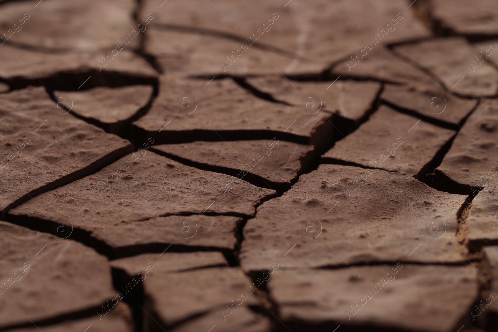 Photo of Dry cracked ground as background, closeup. Global warming