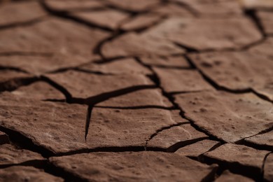 Photo of Dry cracked ground as background, closeup. Global warming