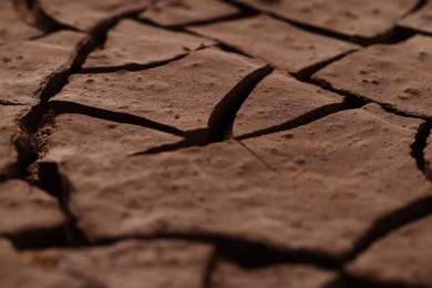 Photo of Dry cracked ground as background, closeup. Global warming