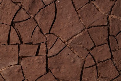 Photo of Dry cracked ground as background, closeup. Global warming